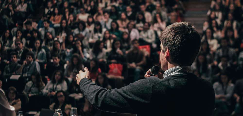 Politician speaking to a full auditorium